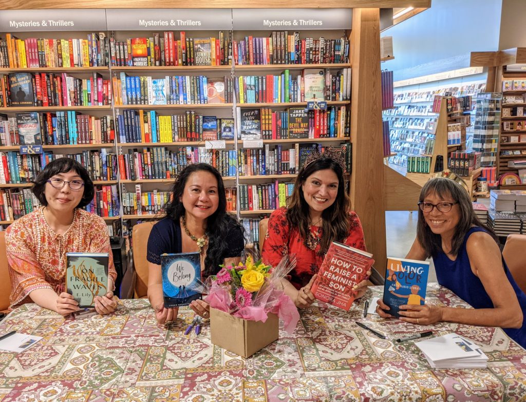 Four writers holding up their books