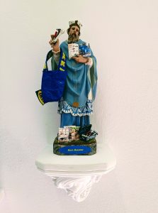Statue of a saint to which consumer items are attached