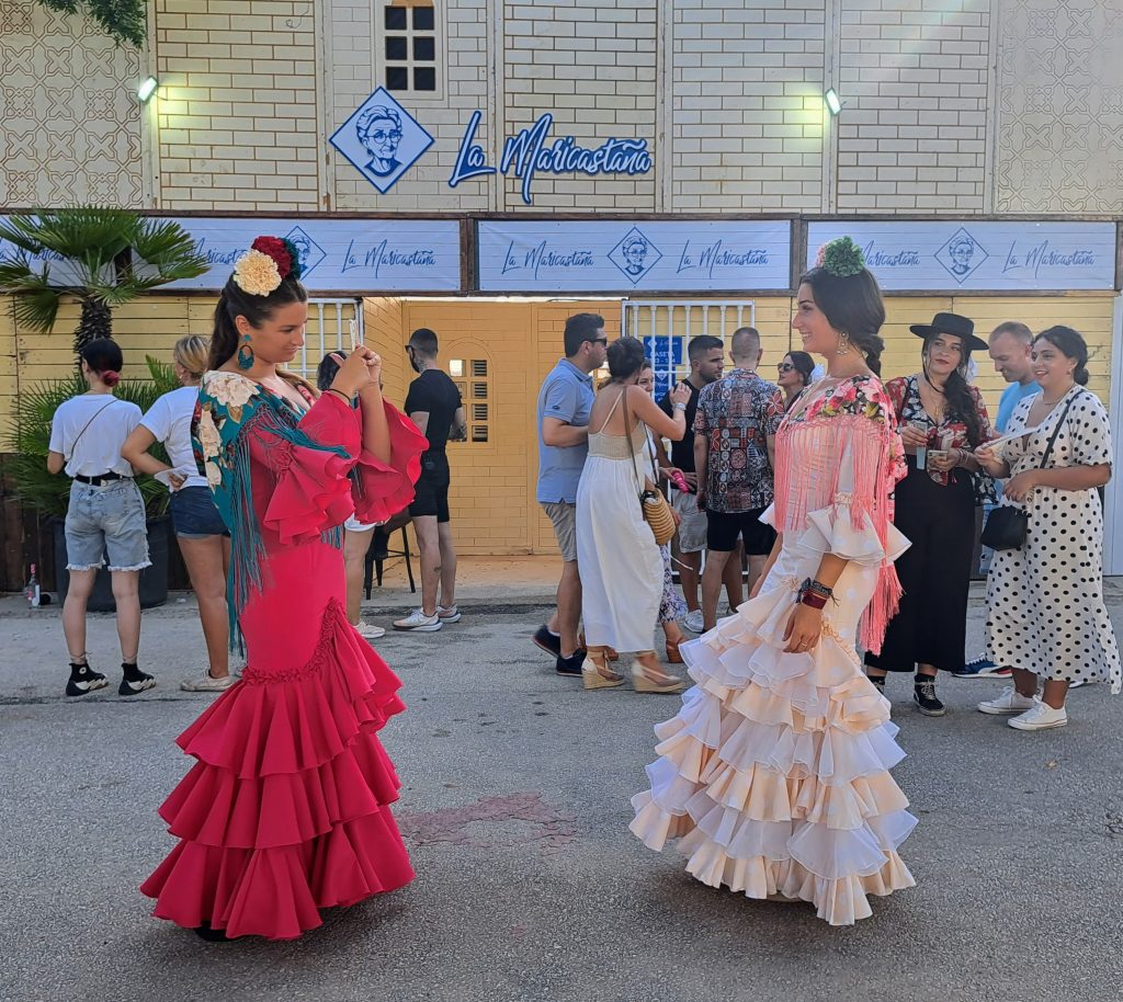 Woman in Flamenco dress taking picture of another woman in Flamenco dress