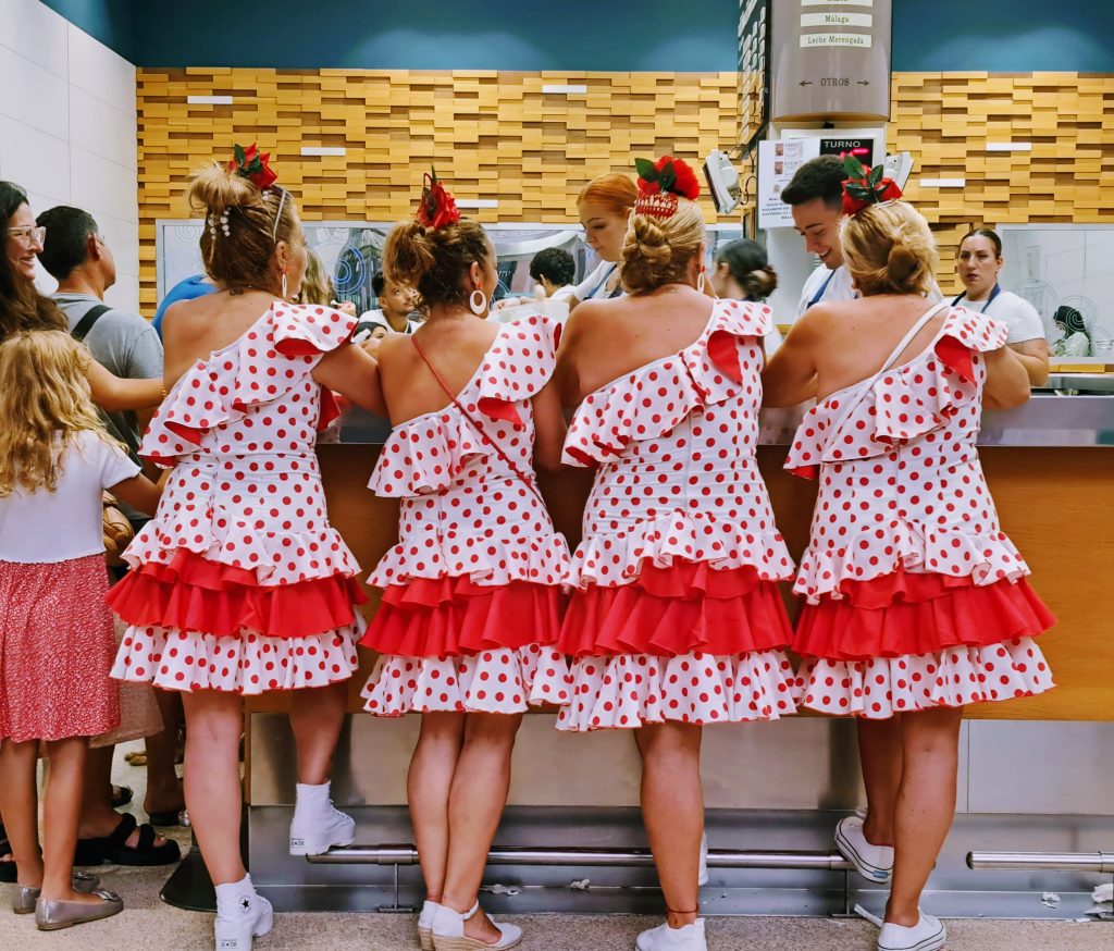 Four women in identical Flamenco wear at an ice cream stand
