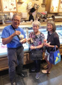 Three Filipino American adults in a gelateria in Madrid