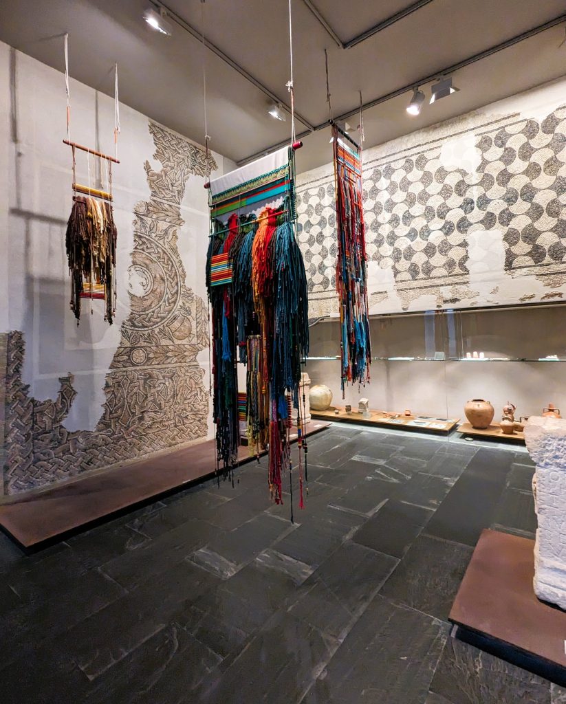 Contemporary weavings hanging with antiquity art