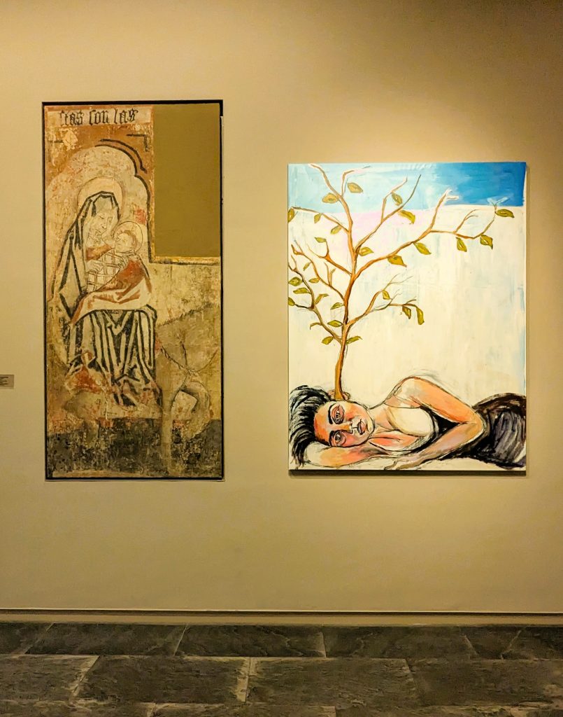 Contemporary painting hanging next to Madonna and child painting