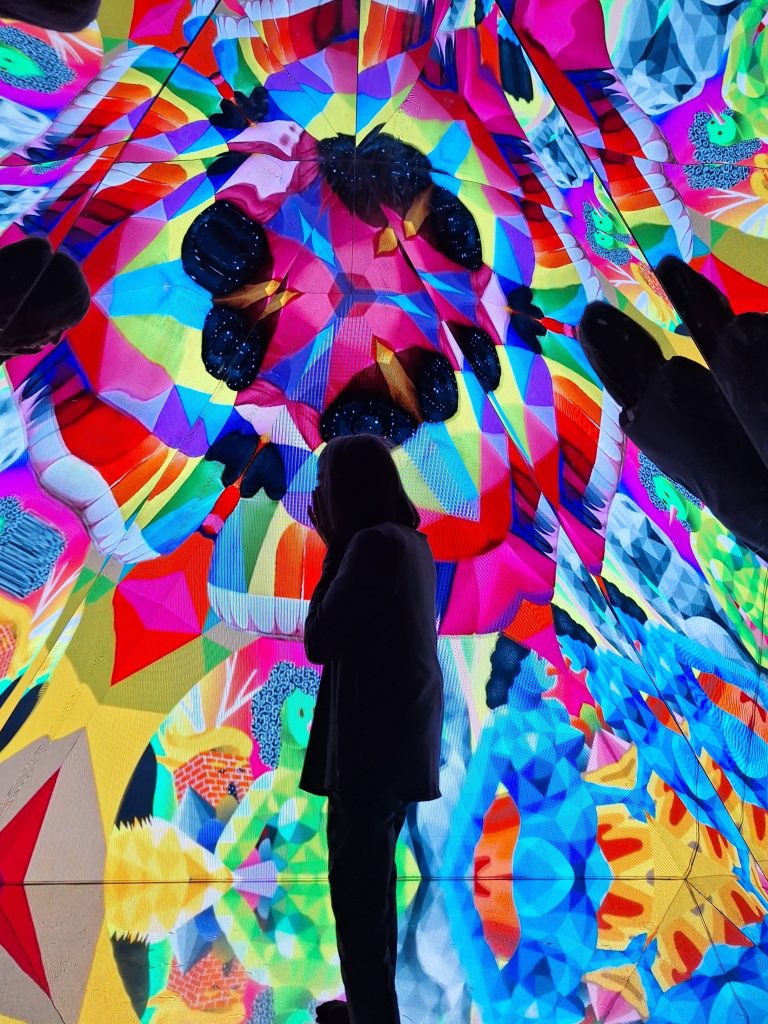 Silhouette of a woman in a kaleidoscope of colors in the background