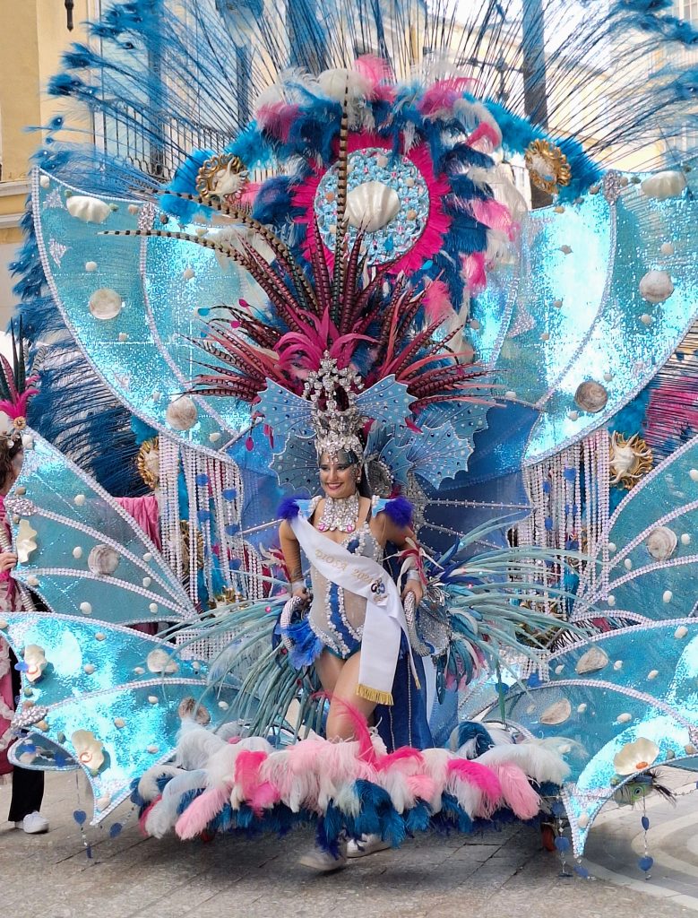 Woman in a large feathery costume on wheels