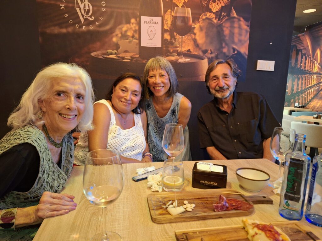 Three women and a man in a wine bar