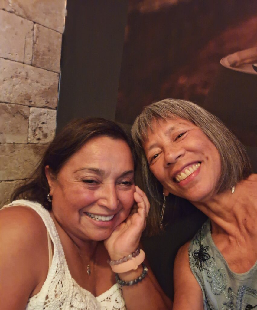 Two brown women smiling