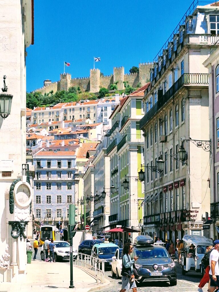 View of city street in Lisbon with the castle of Sao Jorge in the background