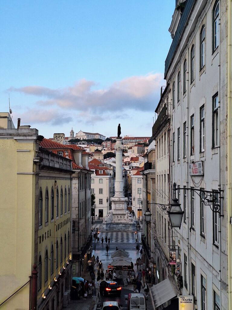 View of street with monument to the King of Portugal in the distance