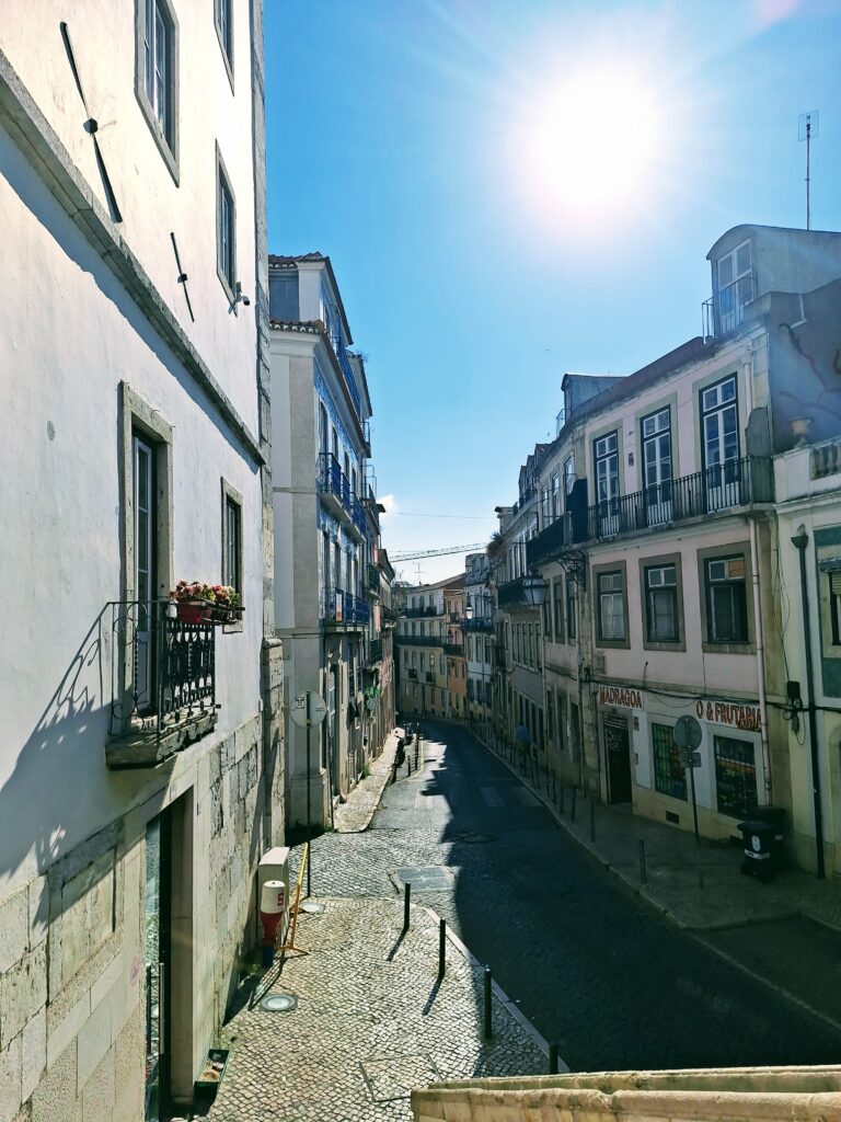 Narrow stone street of old buildings in Lisbon, Portugal