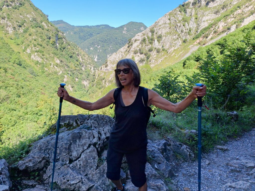 Woman on hiking trail with hiking poles