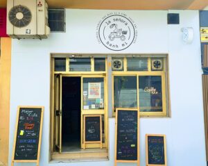 Front of a cafe/bar that sells coffee, beer, and Vietnamese bahn mi and pho