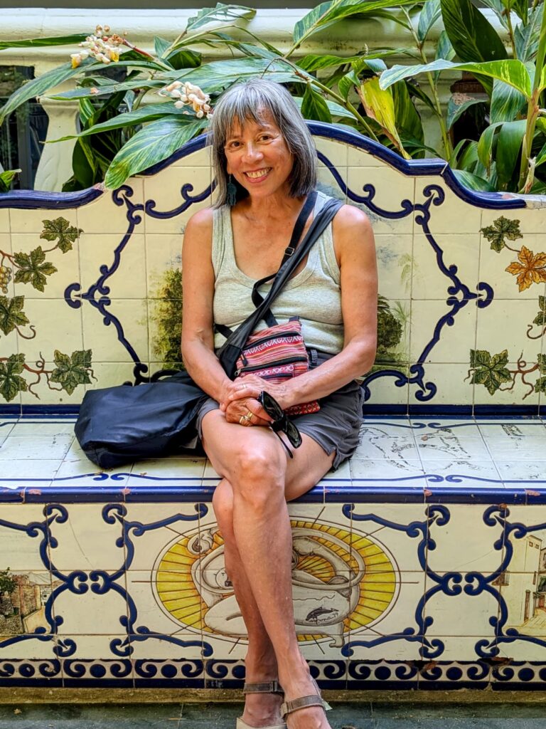 Woman sitting on a ceramic tile bench in a park in Marbella, Spain