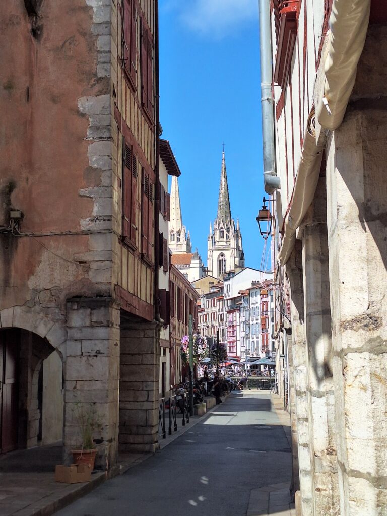 A cobblestone street in Bayonne that leads to the gothic-style cathedral