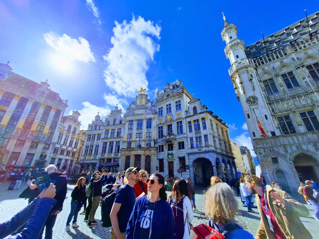 Tourists taking pictures and looking at the sites in Grand Place, Brussels