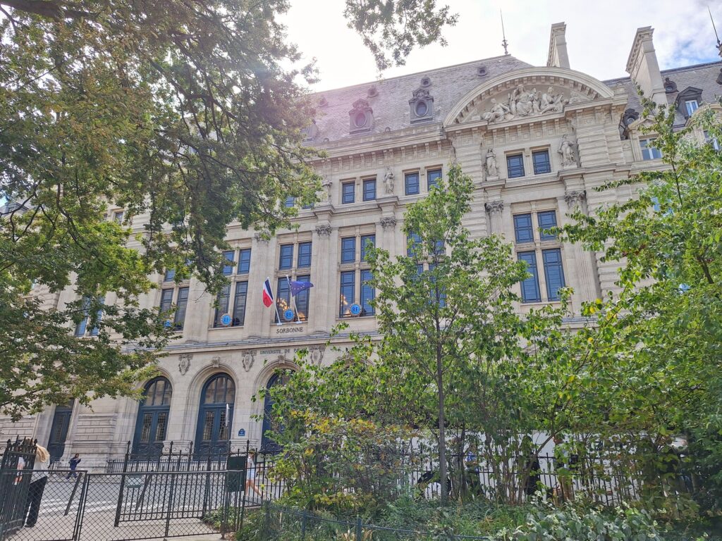 The front of the Sorbonne with trees from the garden across the street in view