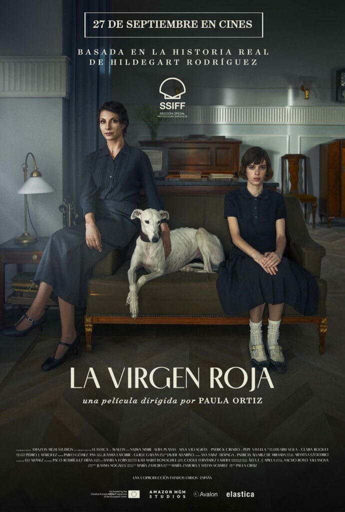Movie poster for the movie La Virgen Roja showing a mother in a gray dress setting on the arm of a sofa on the left, a daughter in a dark dress sitting on the right side of the sofa and a white dog seated in between them. The living room setting is in neutral colors and the whole effect is somber.