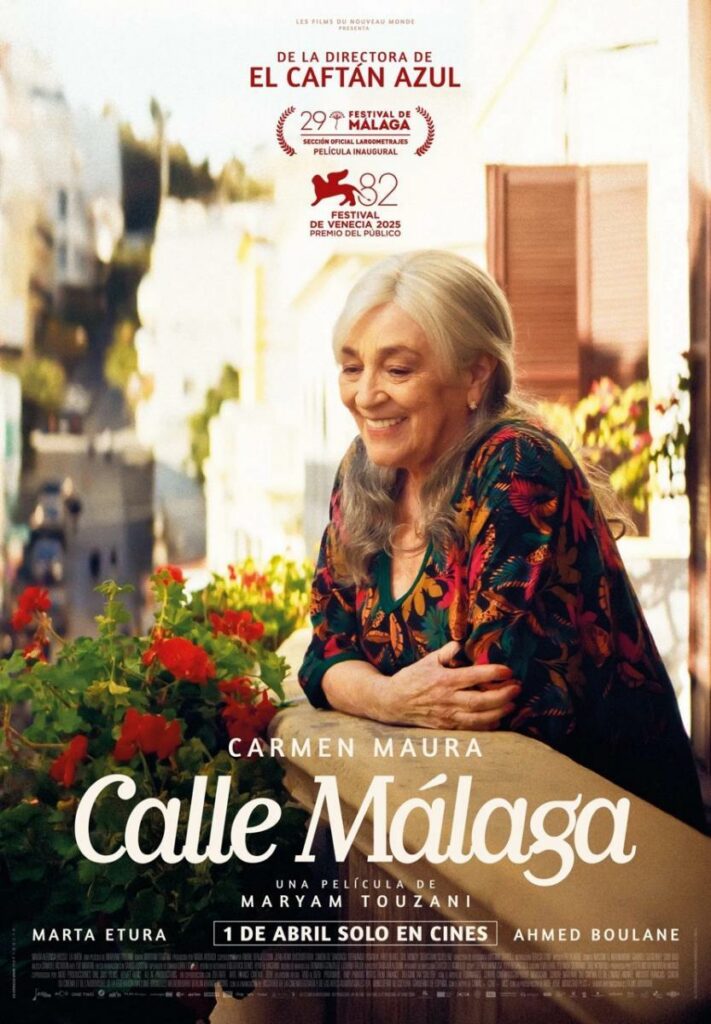 Movie poster for Calle Malaga showing an elderly woman leanig over a balcony with geraniums. Her elbows are crossed on the rail and she is smiling.
